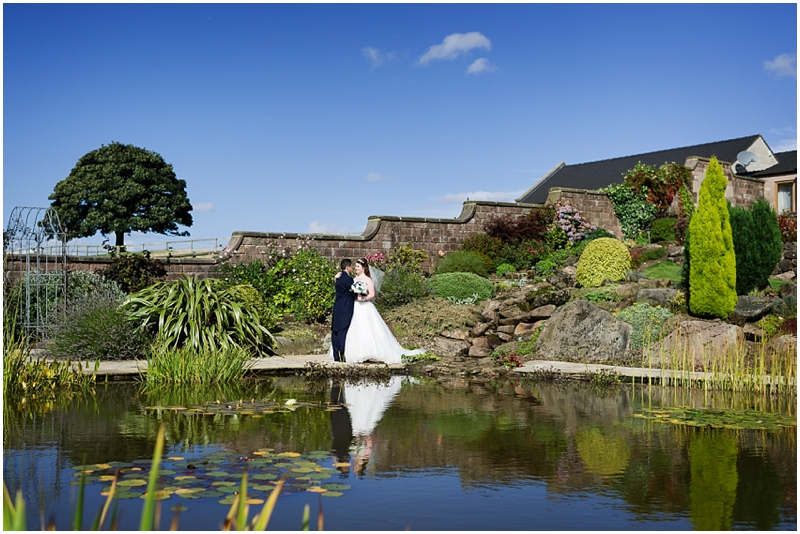bride and groom heaton house farm water gardens