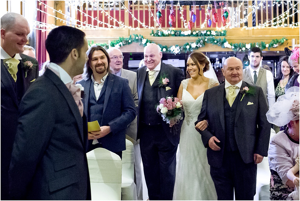 bride coming down the isle at hundred house