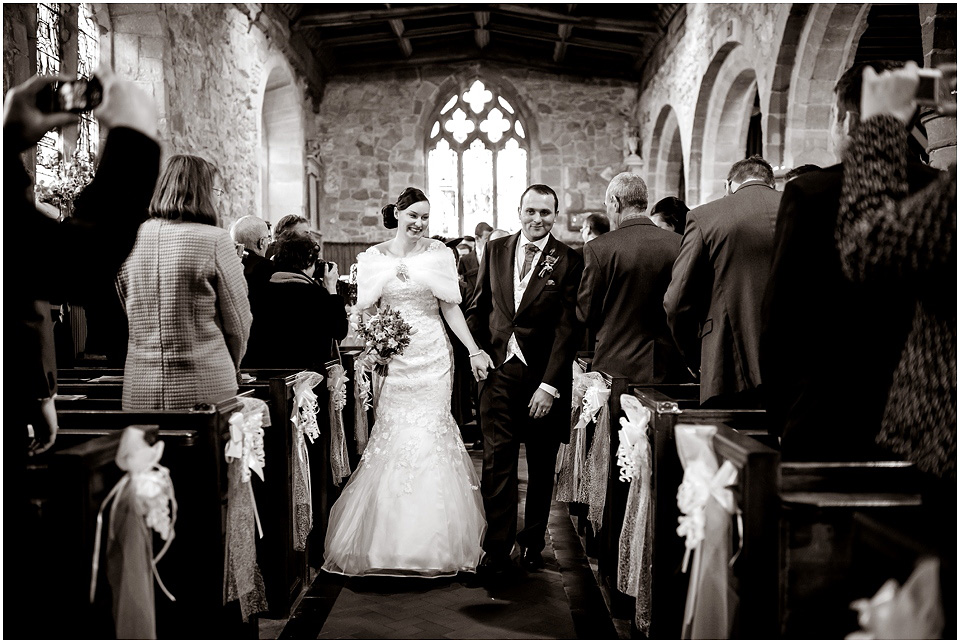 bride and groom walking down isle