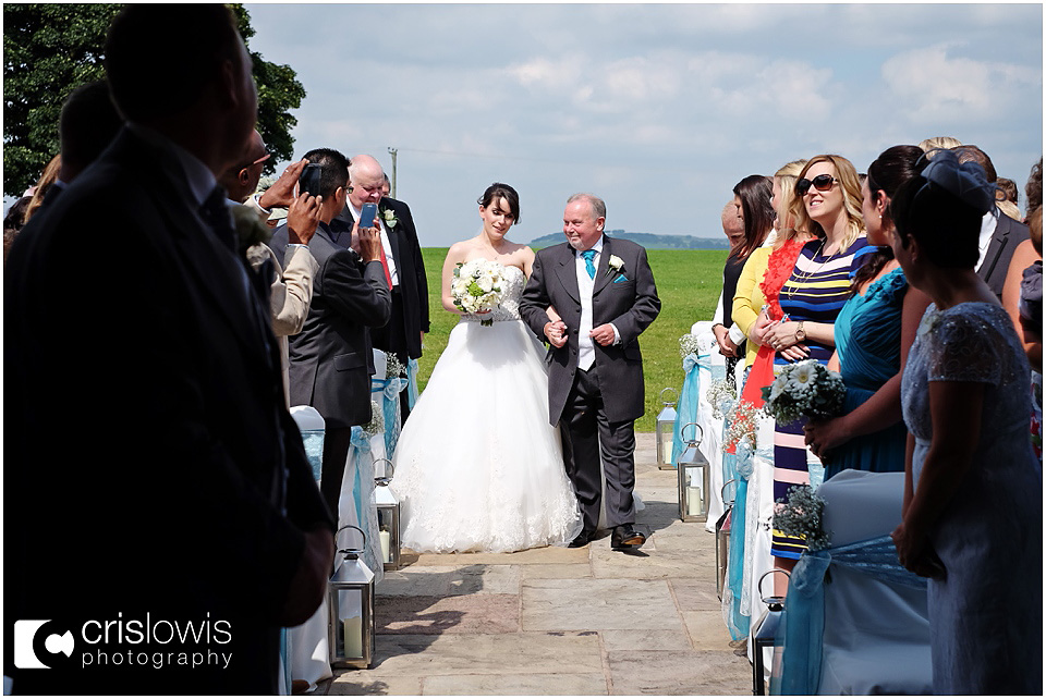 bride walking down outdoor isle