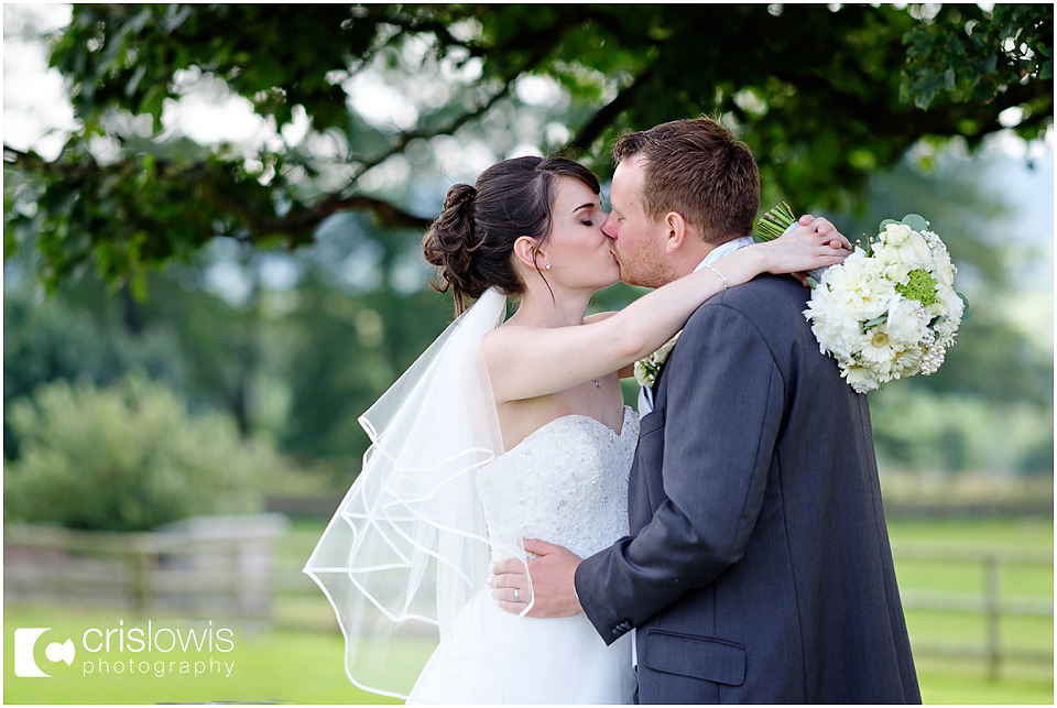 bride and groom under tree at heaton house farm