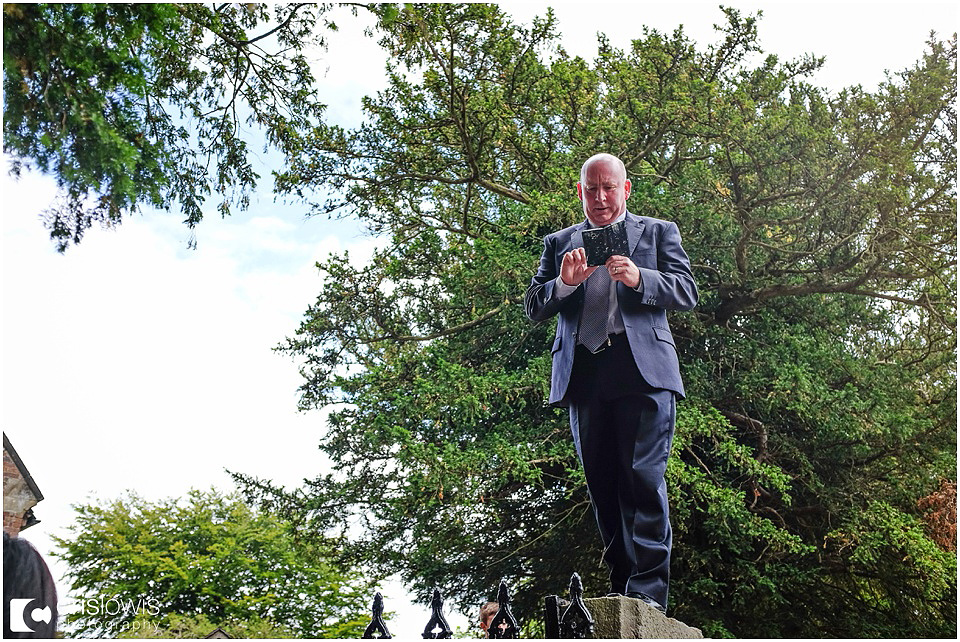 wedding guest standing on top of a wall