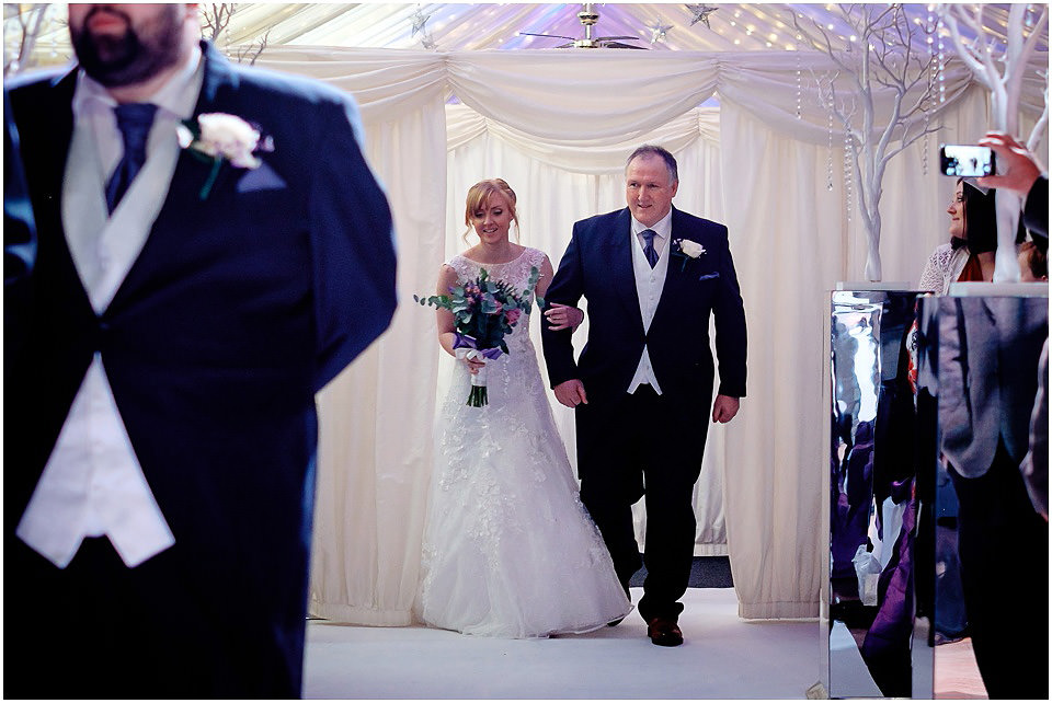 bride and father walking into ceremony room