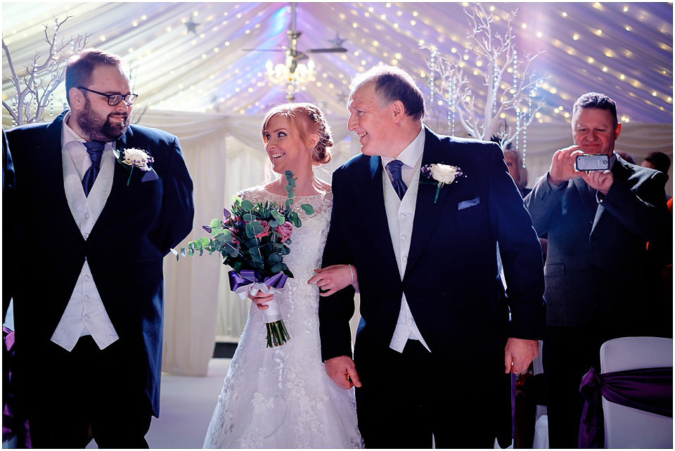 bride and father walking into ceremony room