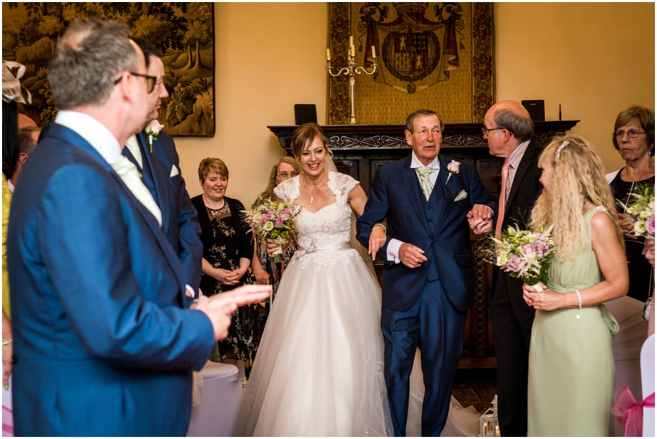 bride walks down the isle with dad
