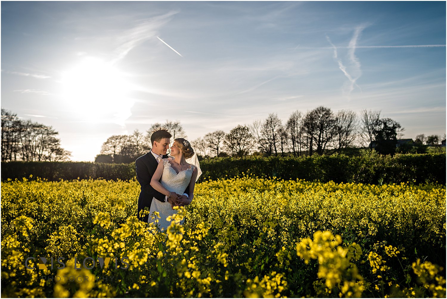 bride and groom portraits in oil seed rape field