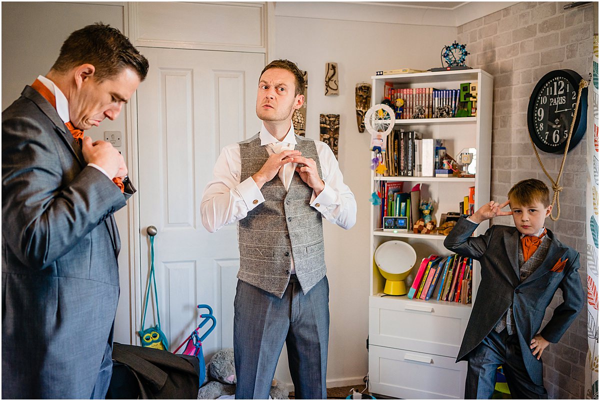 groom tying tie