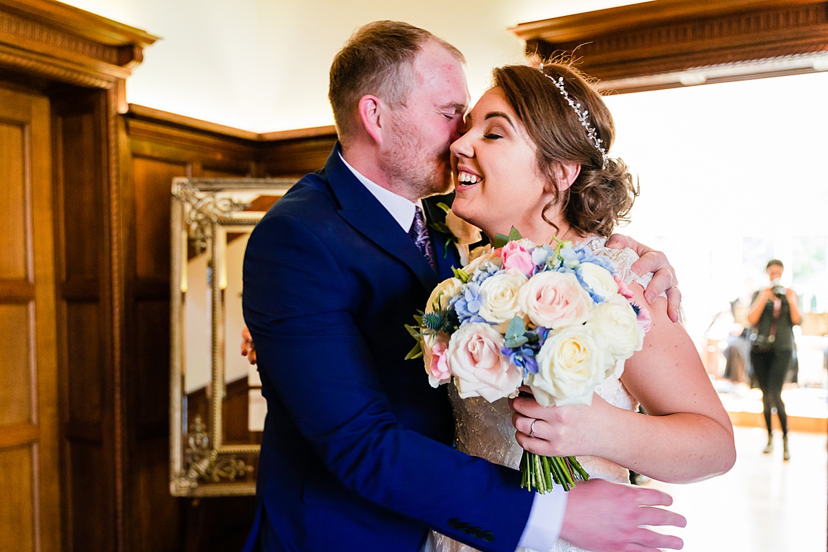 bride and groom cuddle after wedding