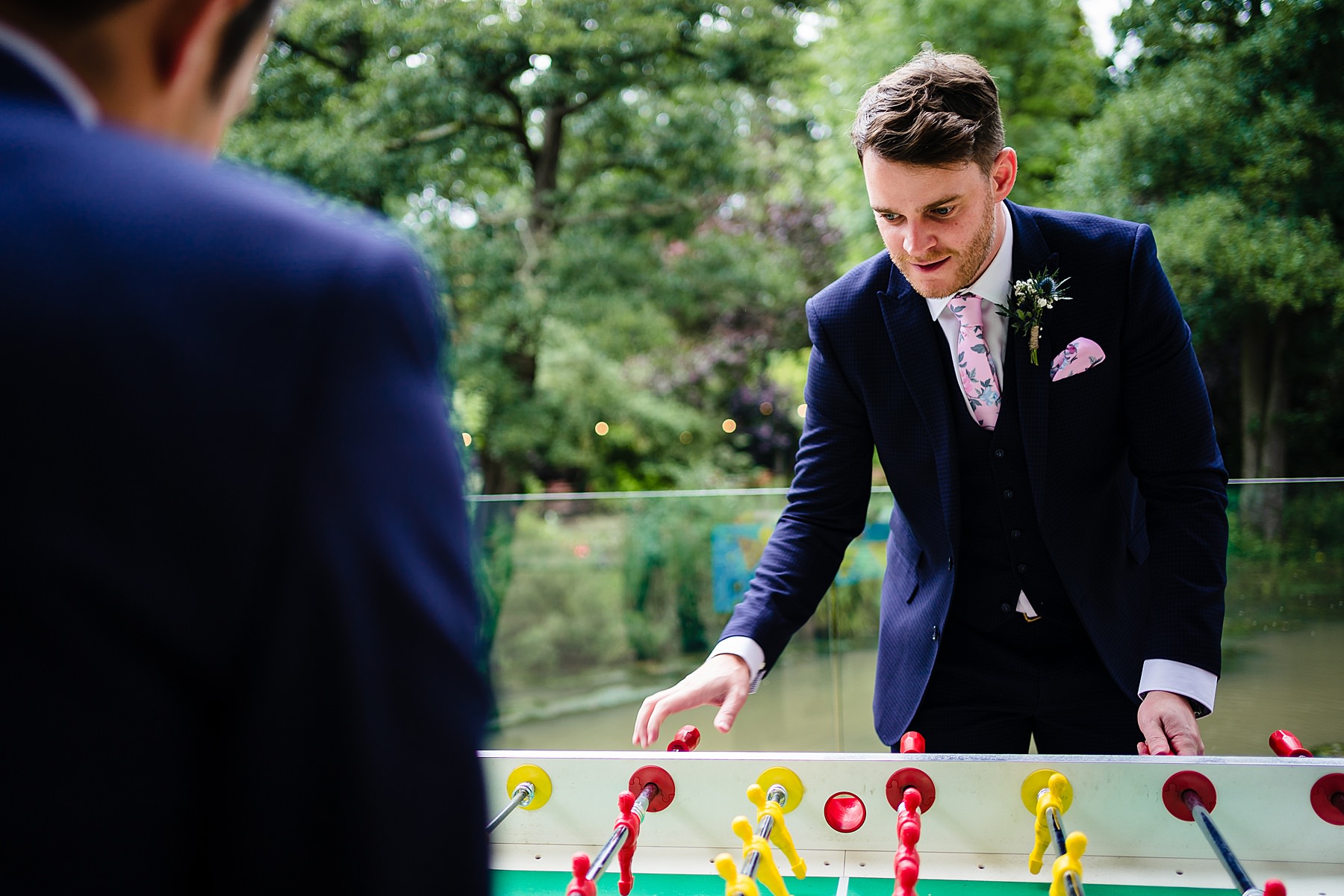 groomsmen playing table football