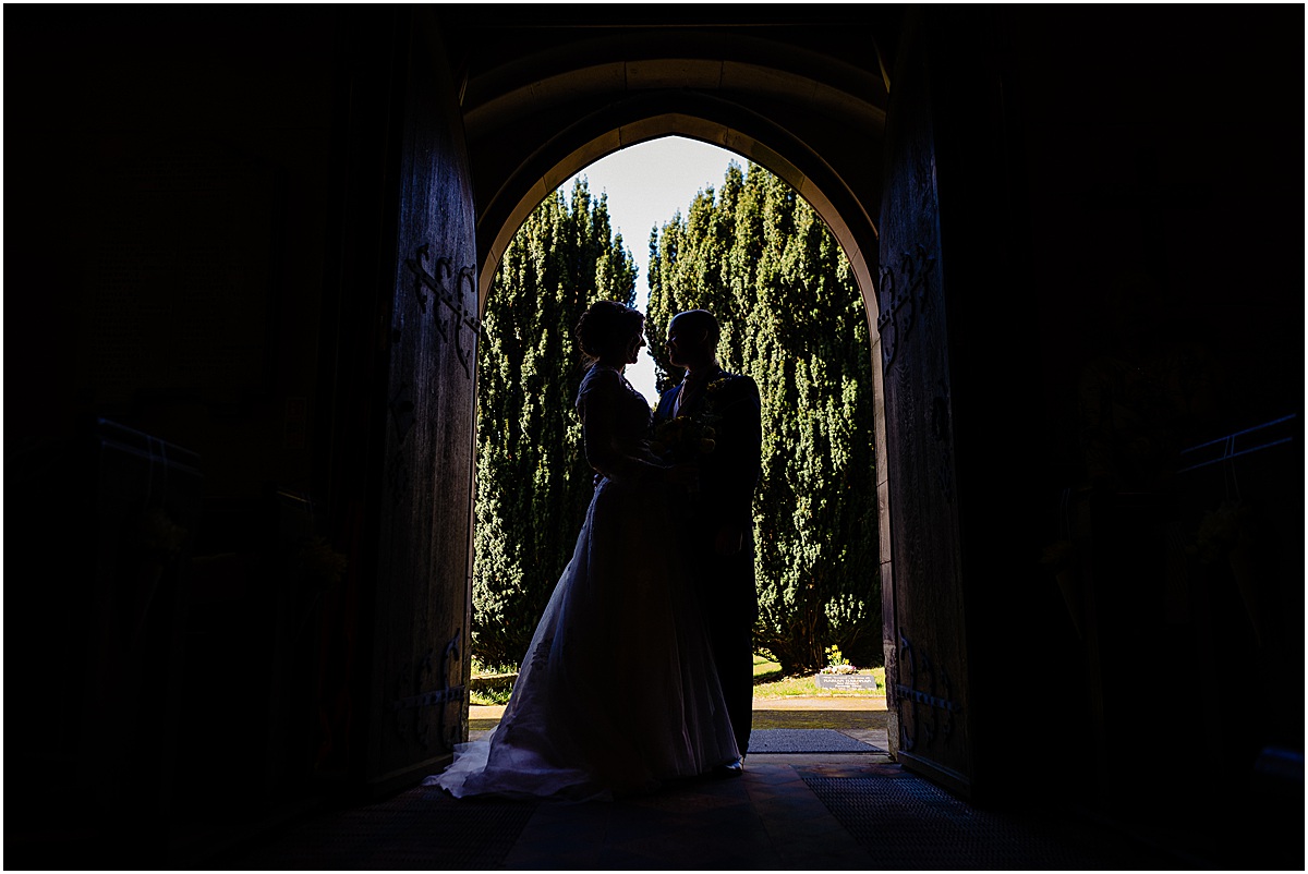 bride and groom in doorway of church