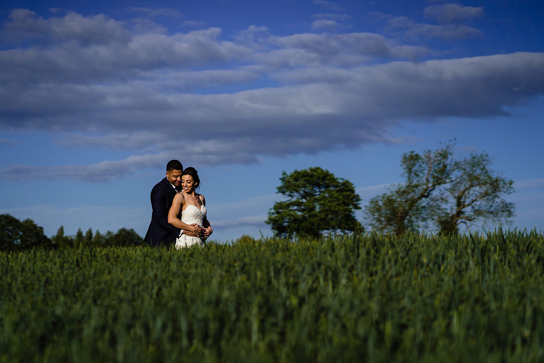 bride and groom in cornfield