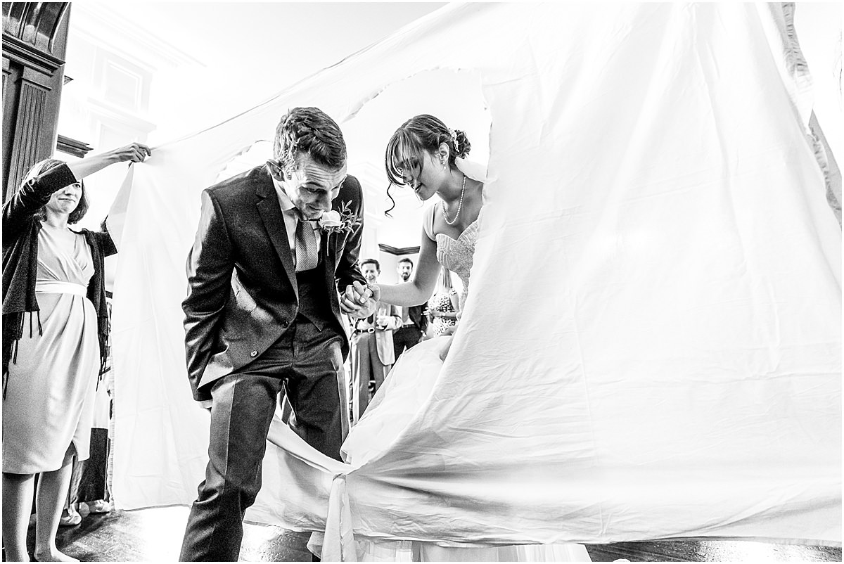 cutting the bed sheet at a wedding