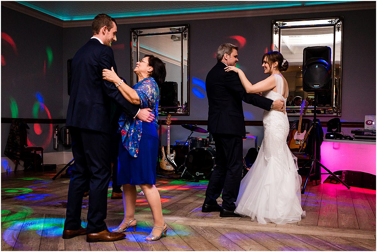 couple and their parents dancing