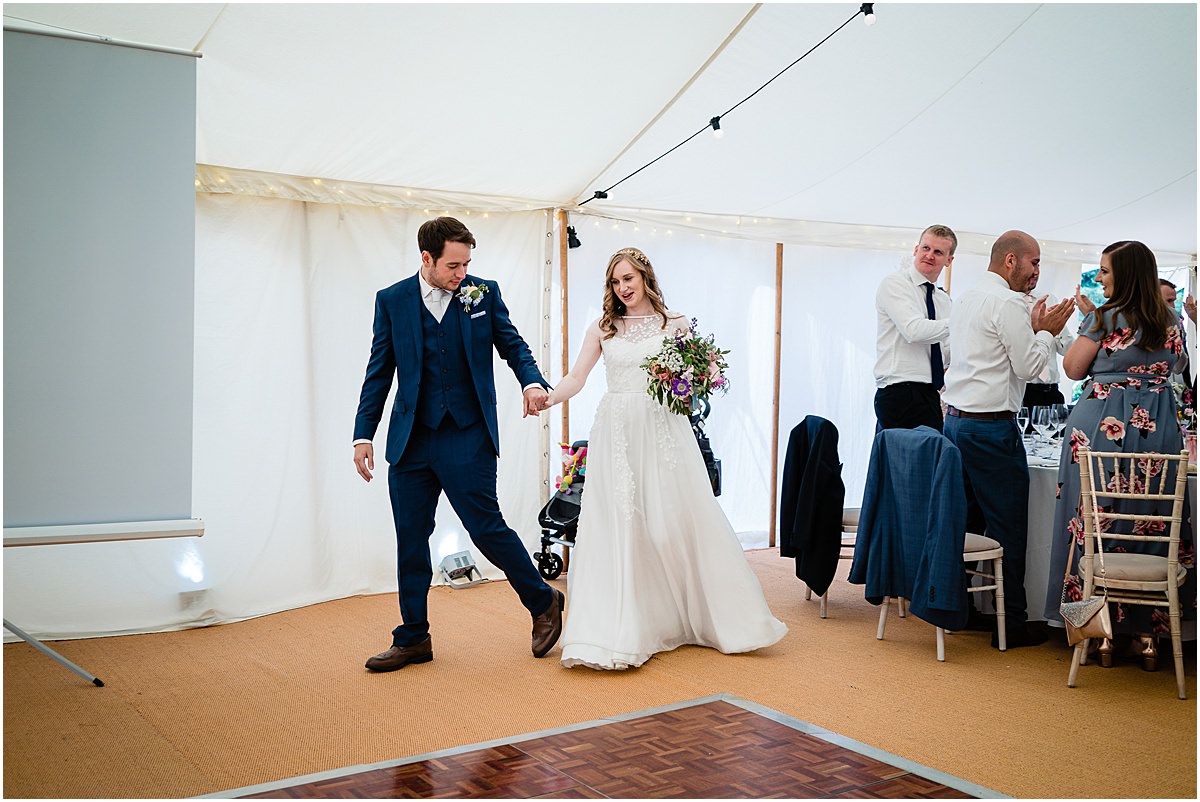 bride and groom enter room