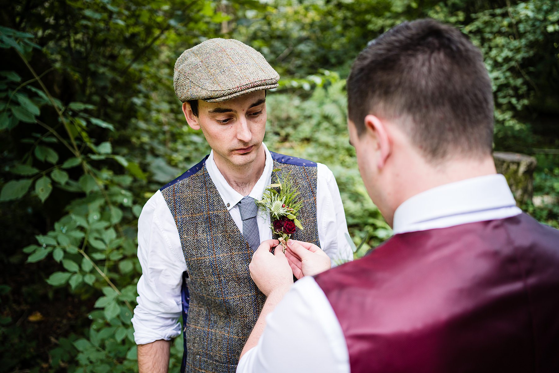 groom getting button hole attached
