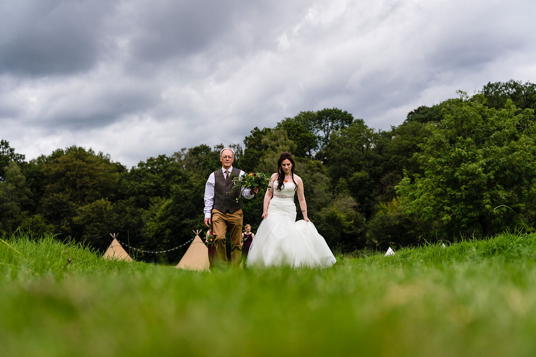 bride and dad walking to wedding ceremony