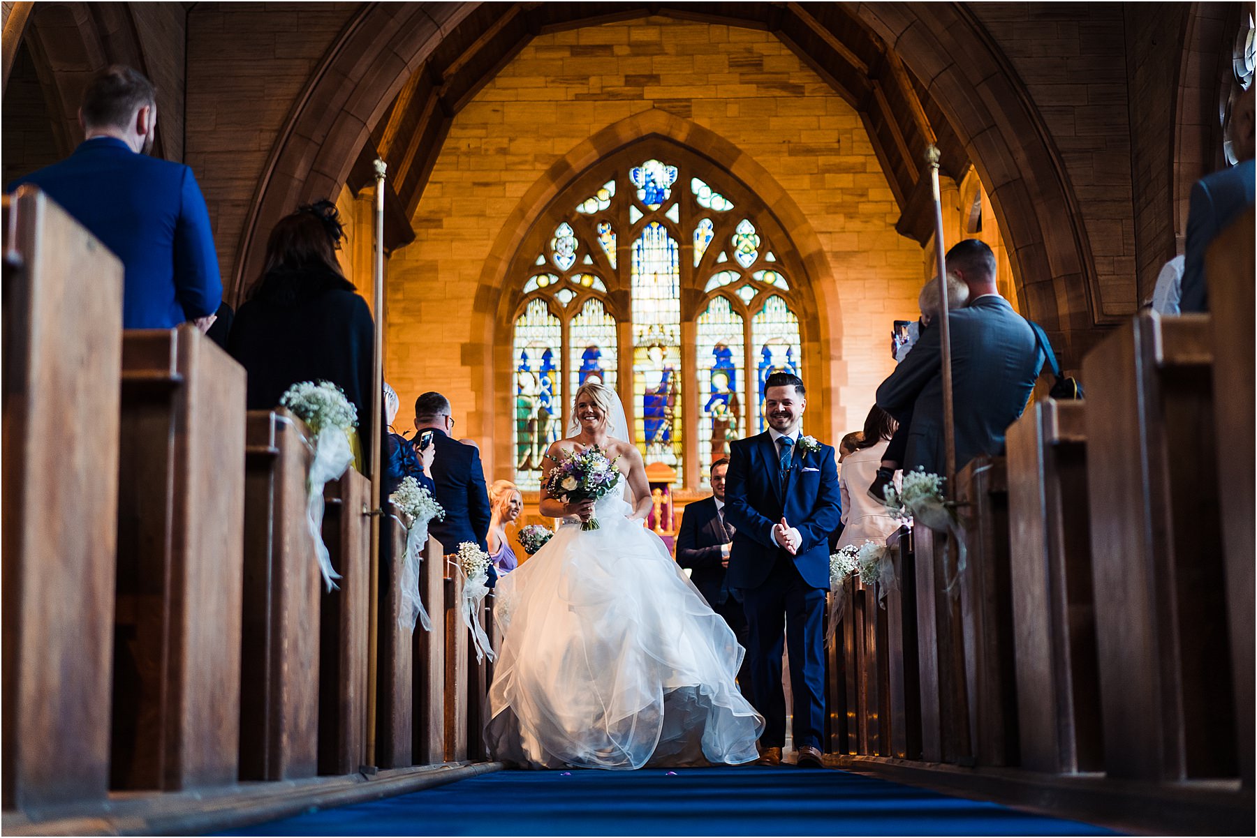 bride and groom leave the church