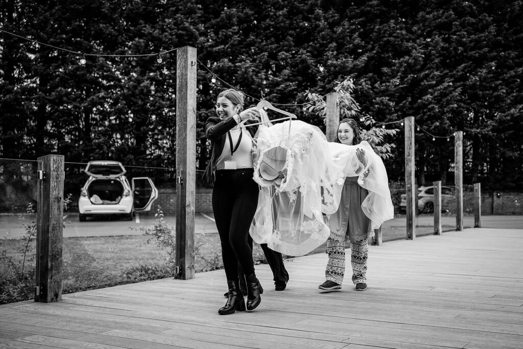 bridesmaids arriving with dress